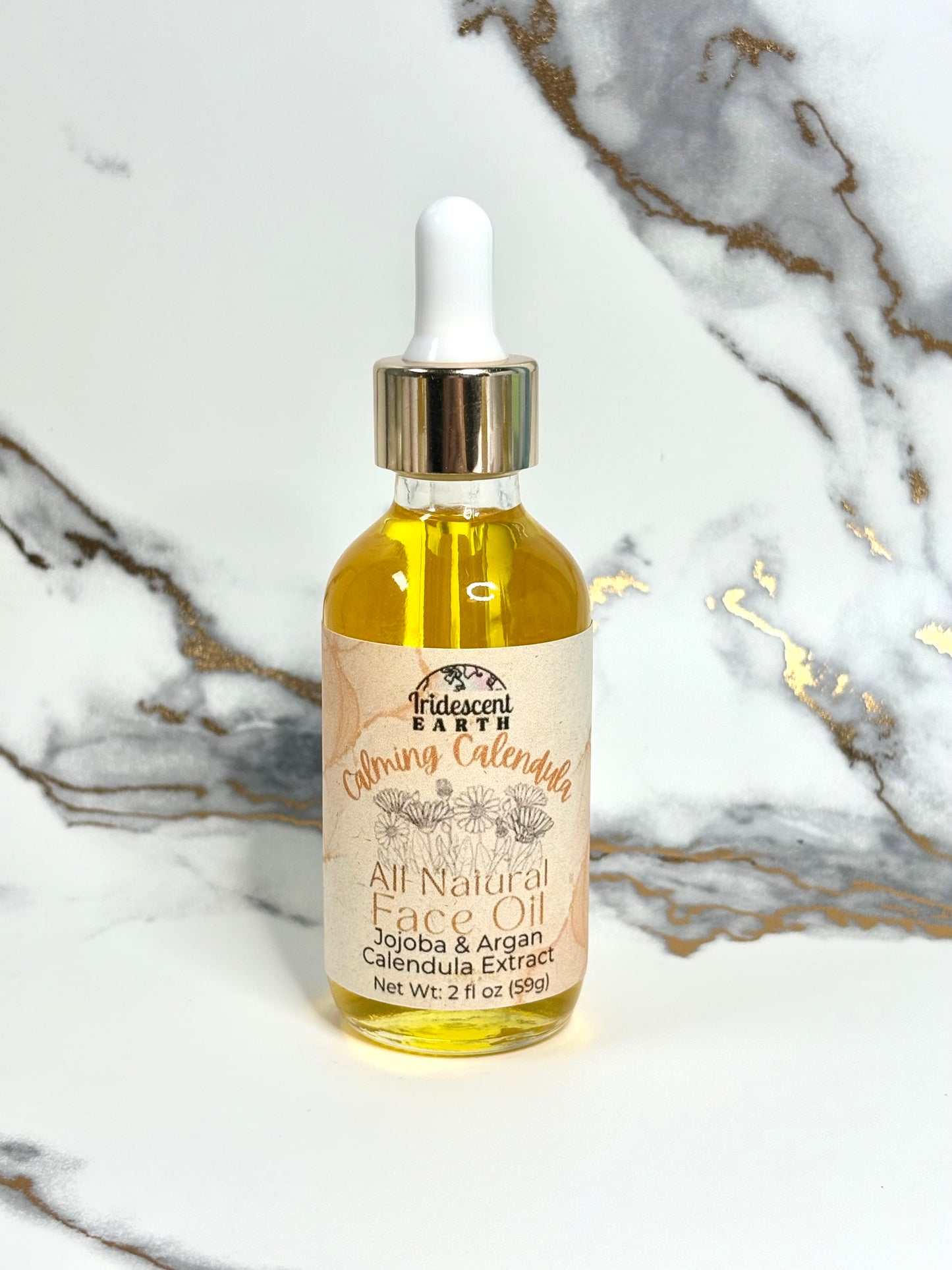 Bottle of All Natural Face Oil with dropper on a marble background