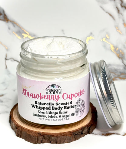 Jar of strawberry cupcake scented whipped body butter on a marble surface