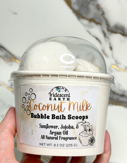 Coconut milk bubble bath scoops in a container with a label on a neutral background