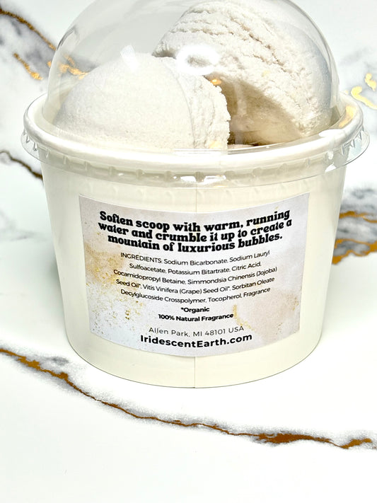 Container of bubble bath scoops with a label on a marble surface