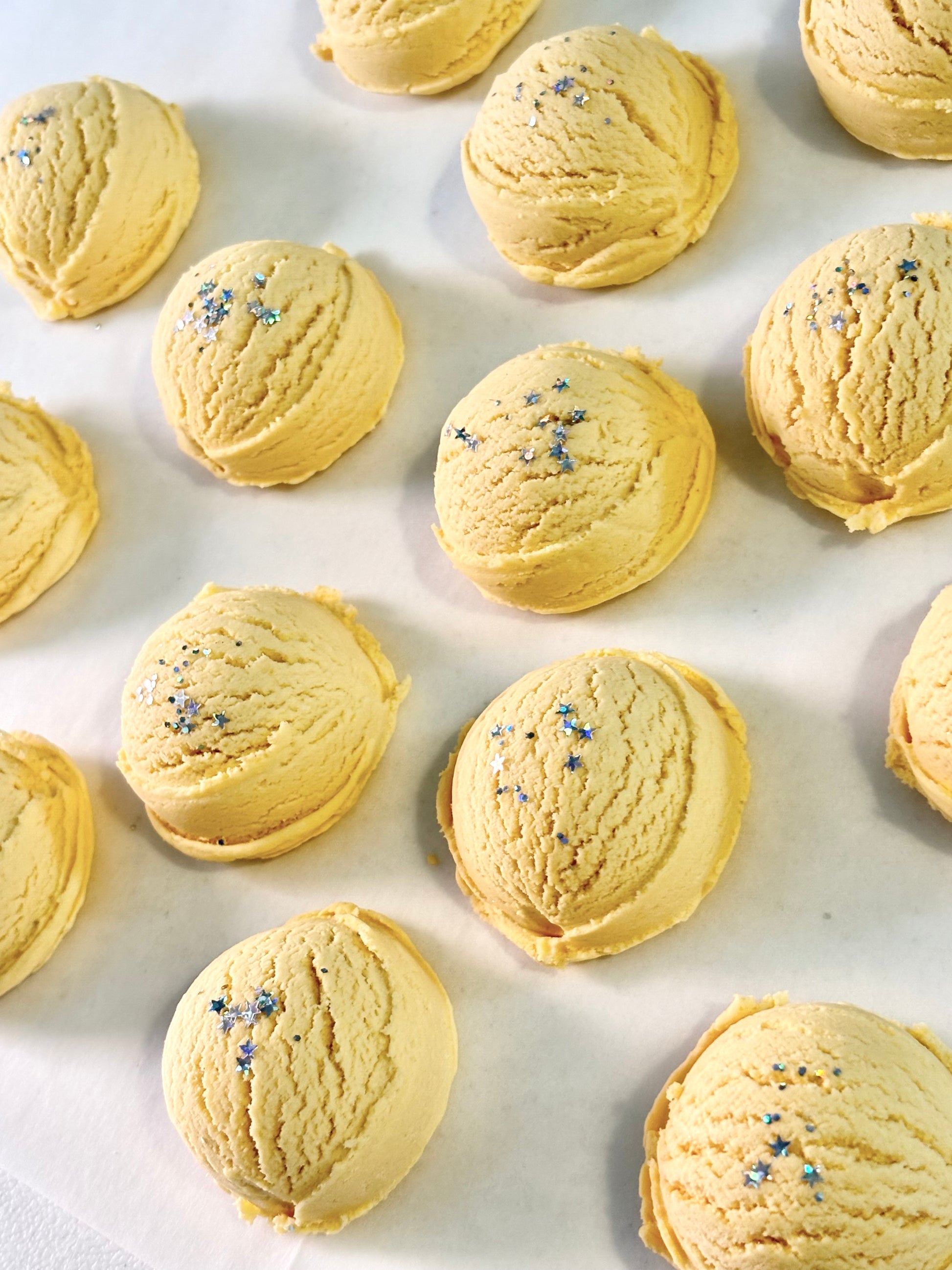 Yellow bubble bath scoops on a white background